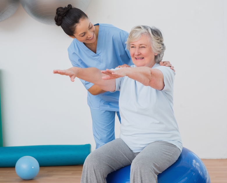instructor-assisting-senior-woman-exercising